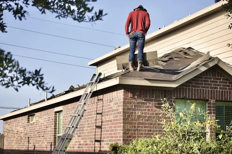 Professional roofer working on a residential roof in The Landings